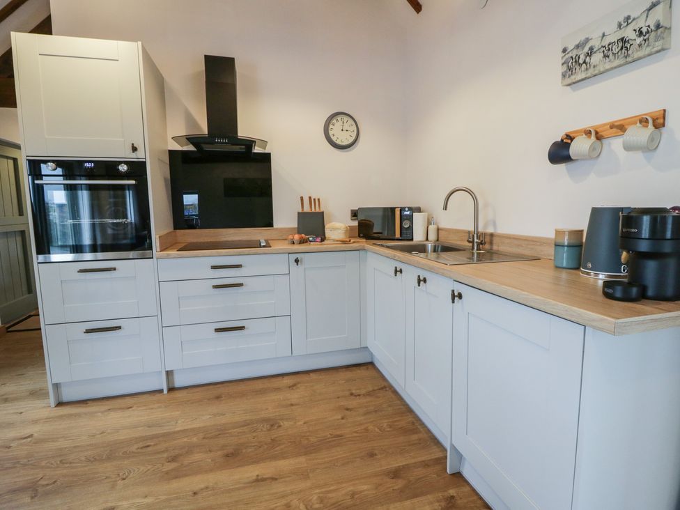A kitchen with cabinets and appliances at Wyn's Barn Nantmel near Rhayader