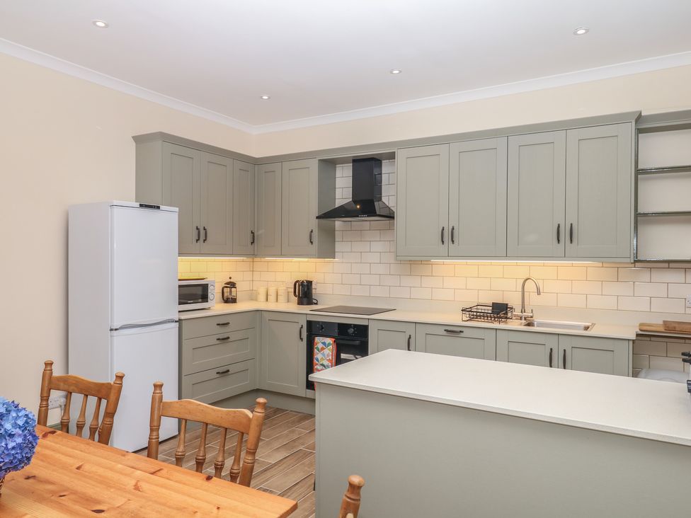 A kitchen with appliances and cabinets at Lukesland Wing in Ivybridge