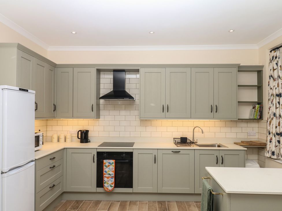 A kitchen with cabinets appliances and a sink at Lukesland Wing Ivybridge