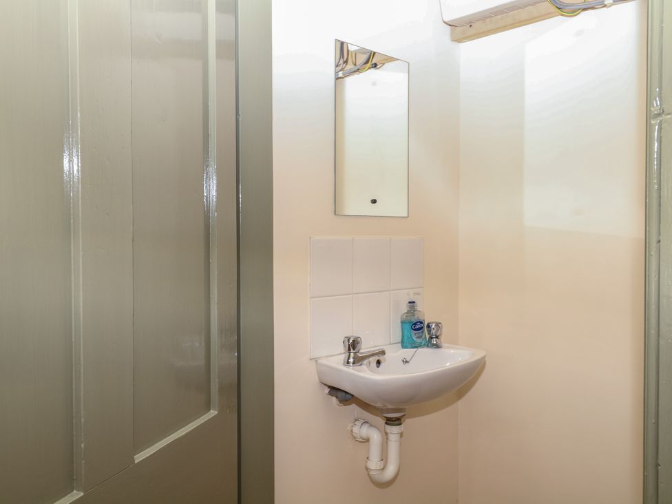 A bathroom with a sink and mirror at Lukesland Wing in Ivybridge