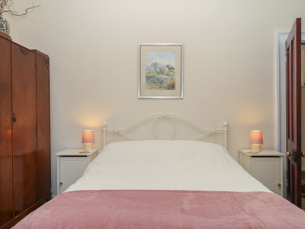 A bedroom with a bed and lamps at Lukesland Wing in Ivybridge