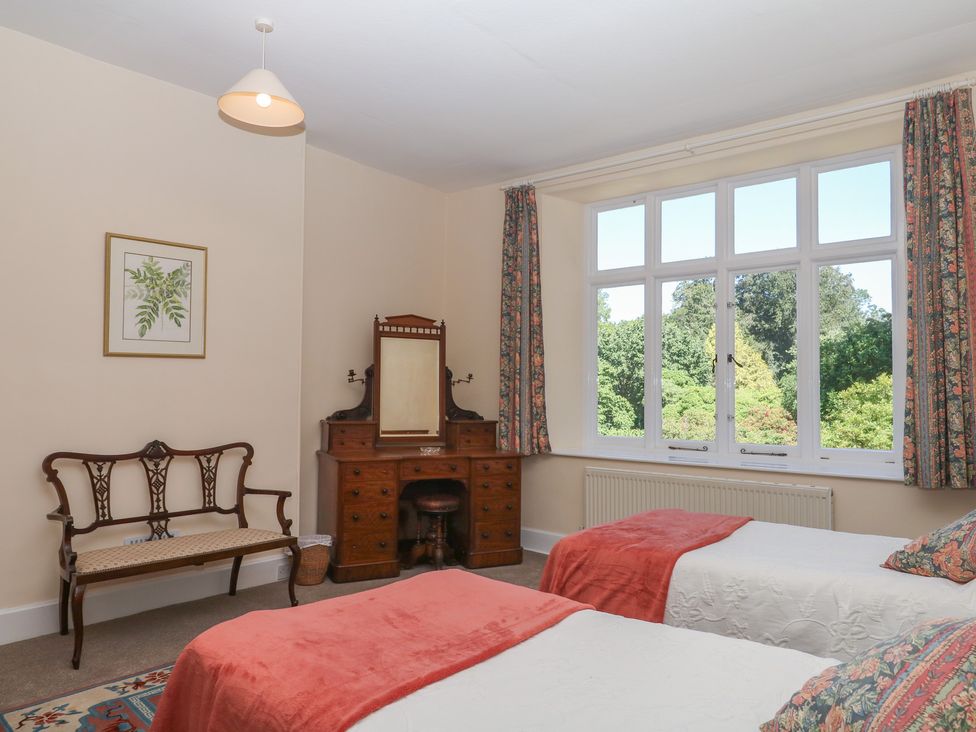 A bedroom with two beds and a vanity unit at Lukesland Wing in Ivybridge