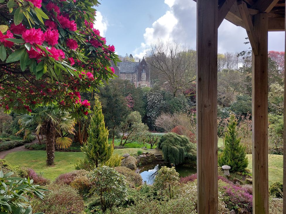 A garden view with flowers and a pond at Lukesland Wing near Ivybridge