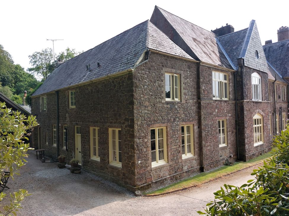 A house with multiple windows and a driveway at Lukesland Wing near Ivybridge