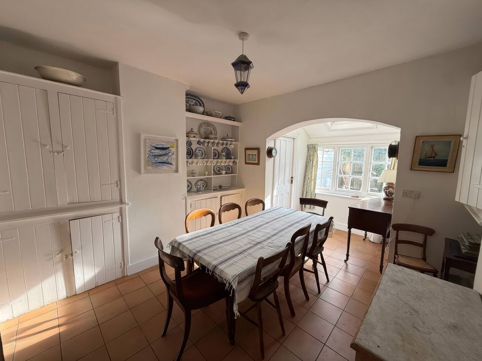 A dining room with a large table and chairs at Avenue Road in Lymington