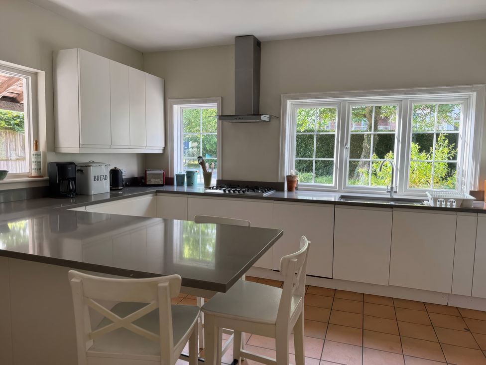 A kitchen with a counter, sink, and stove at Avenue Road in Lymington