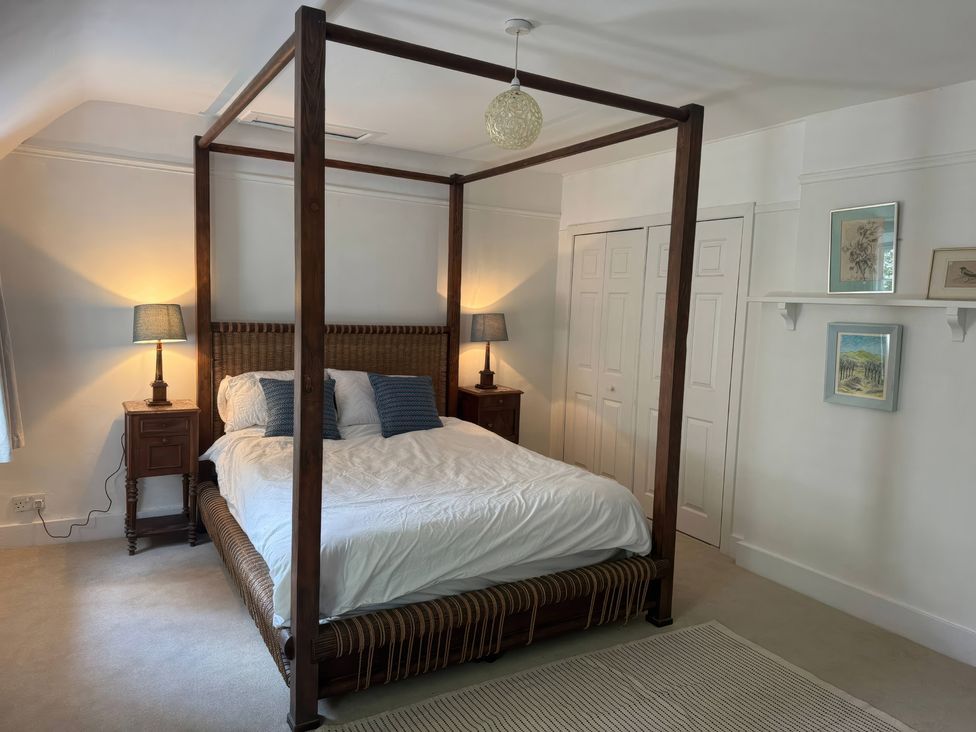 A bedroom with a four-poster bed and nightstands at Avenue Road in Lymington