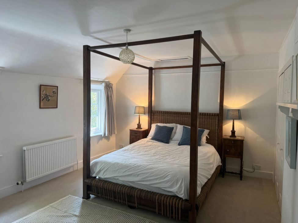 A bedroom with a four-poster bed and bedside tables at Avenue Road in Lymington
