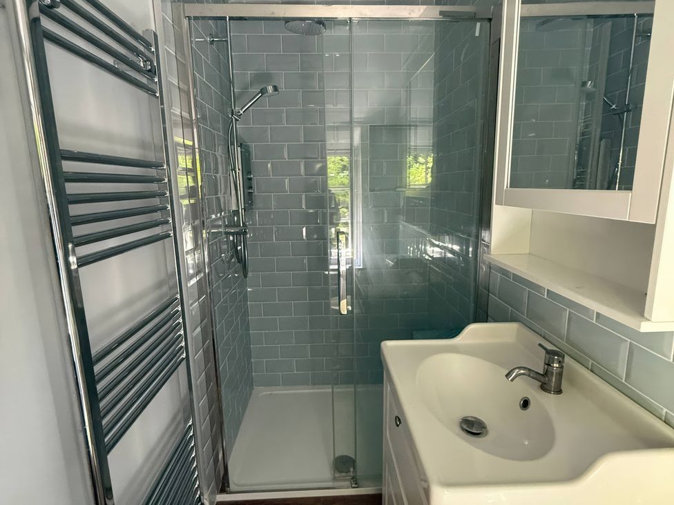 A bathroom with a shower and sink at Avenue Road in Lymington