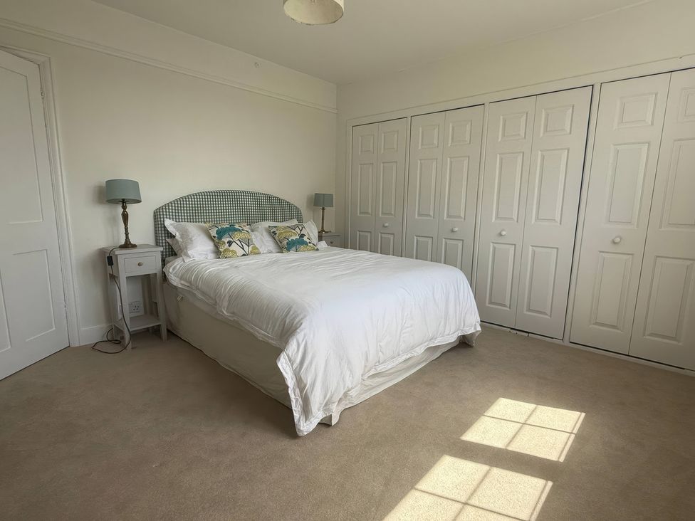 A bedroom with a bed and wardrobe at Avenue Road in Lymington