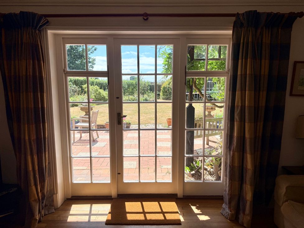 Double doors leading to a patio with garden view at Avenue Road in Lymington