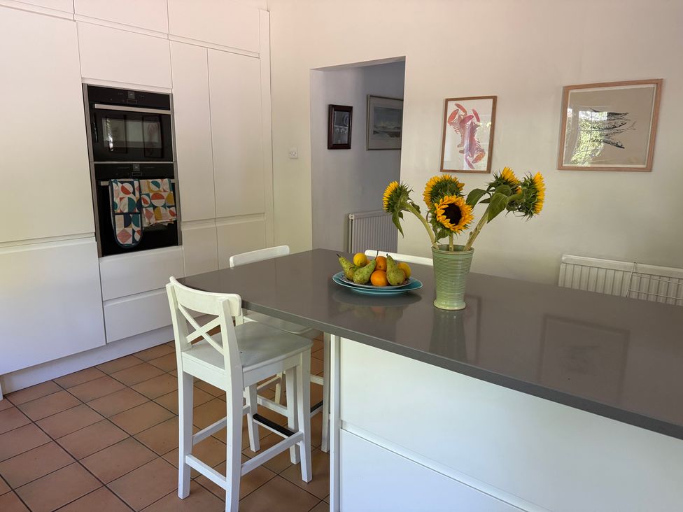 A kitchen with a countertop, flowers and fruit bowl at Avenue Road in Lymington