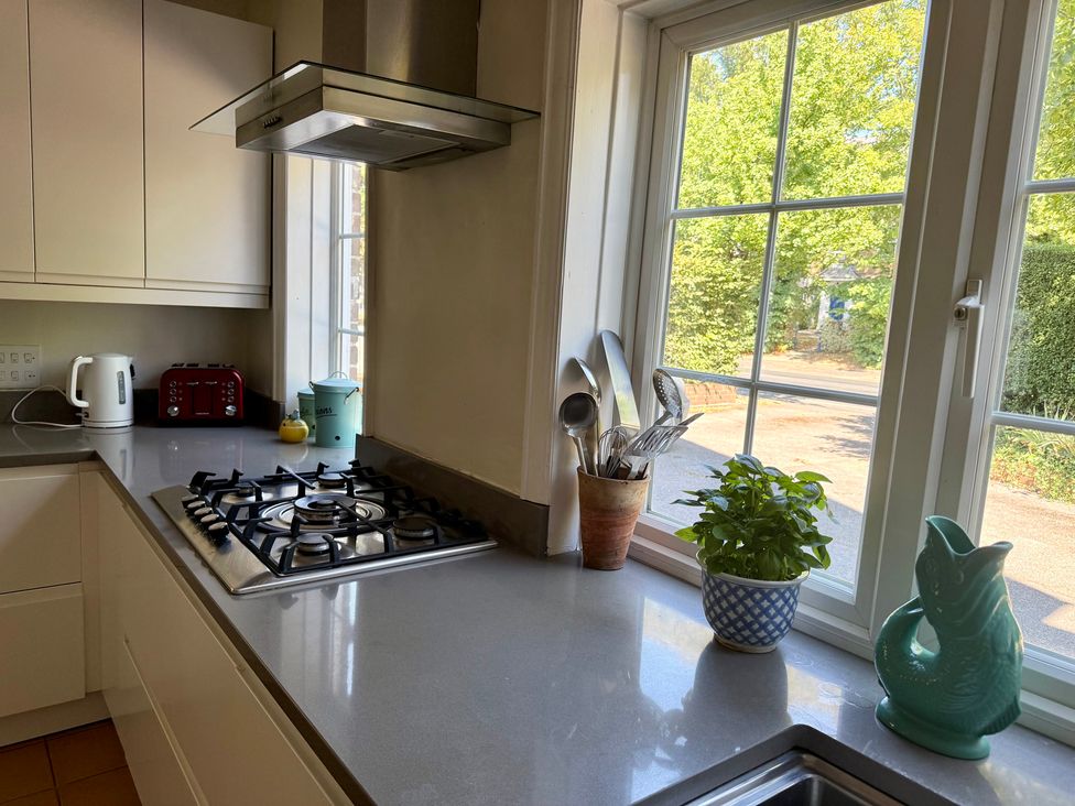 A kitchen with a gas stove and utensils at Avenue Road in Lymington