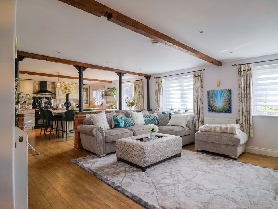 A living room with a sofa and ottoman at The Coach House in Dorchester