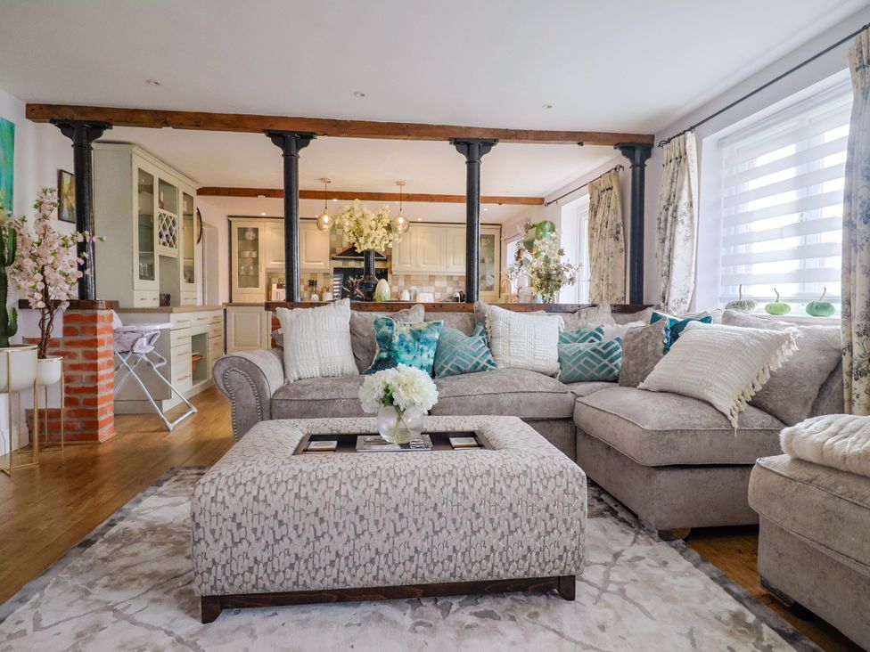 A living room with sofa and coffee table at The Coach House in Dorchester