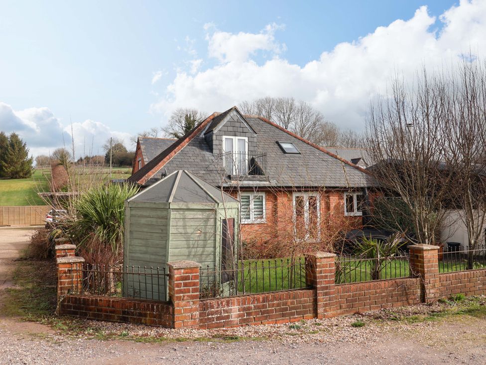 A house with a garden shed and vegetation at The Coach House in Dorchester