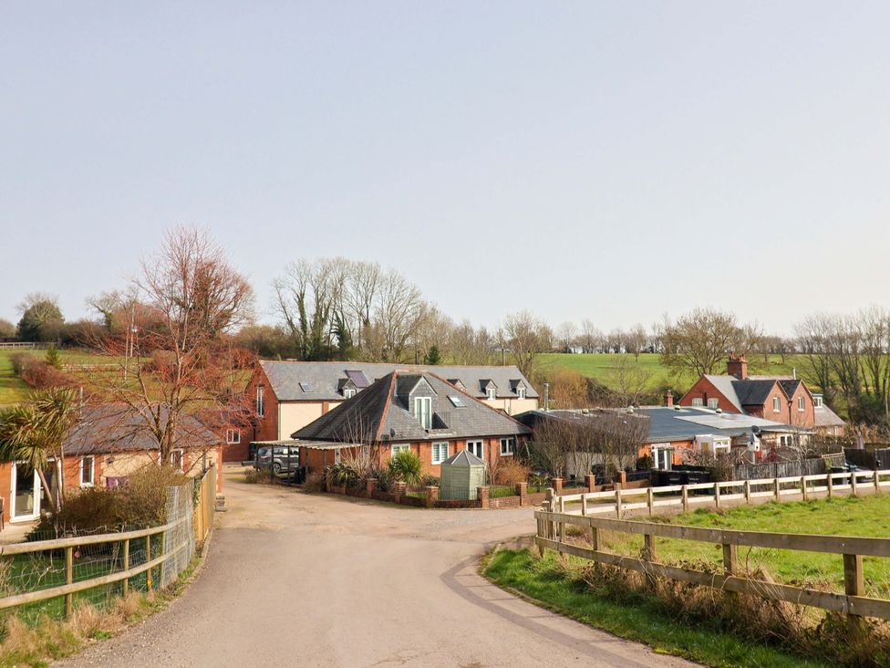 An outdoor view of multiple houses and greenery at The Coach House in Dorchester