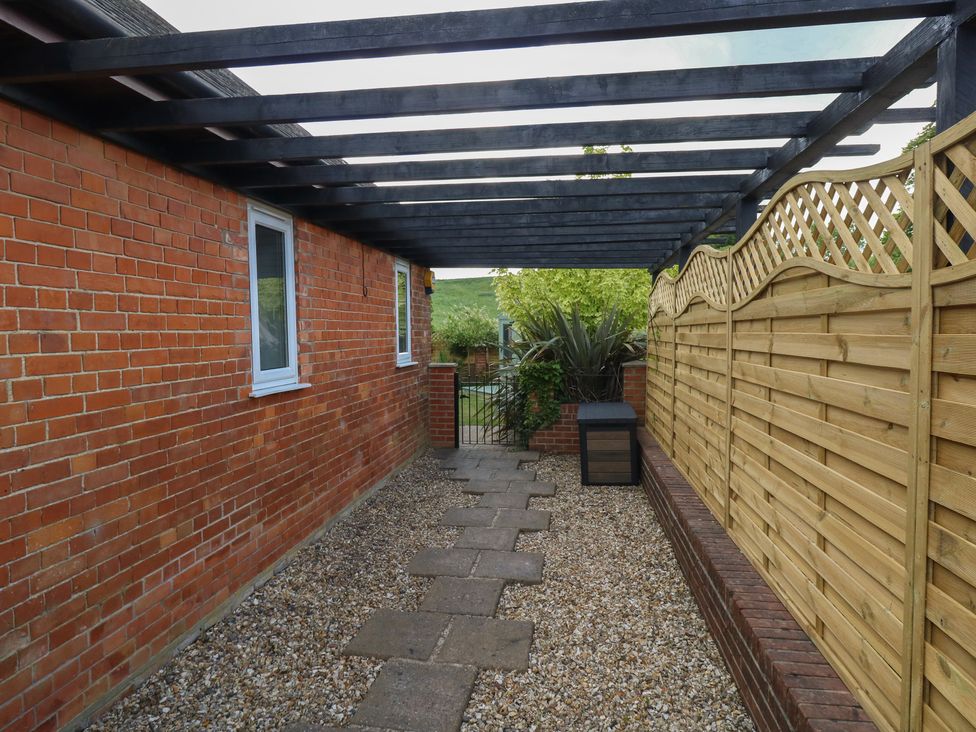 An outdoor space with a path and fencing at The Coach House Near Charminster