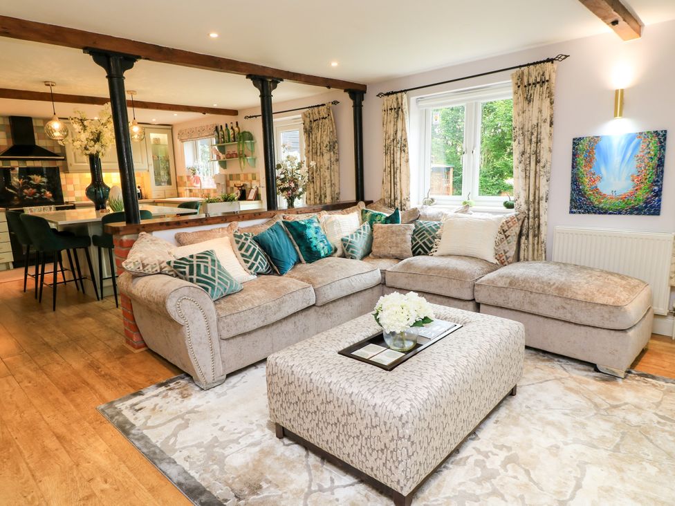 A living room with a sofa and coffee table at The Coach House near Charminster