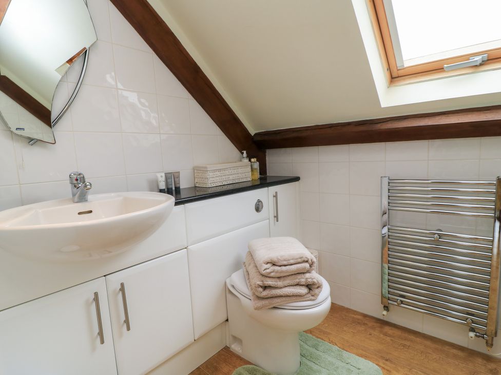 A bathroom with a sink and toilet at The Coach House Near Charminster