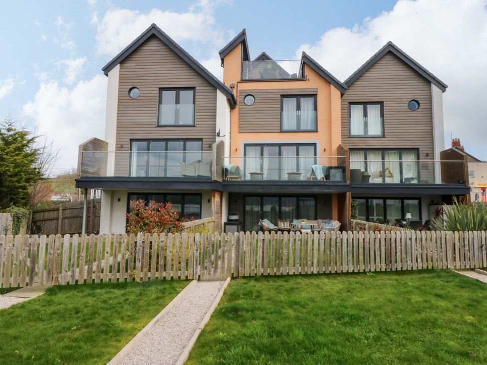 A house with balconies and a fenced yard at 2 Glan Yr Aber in Colwyn Bay