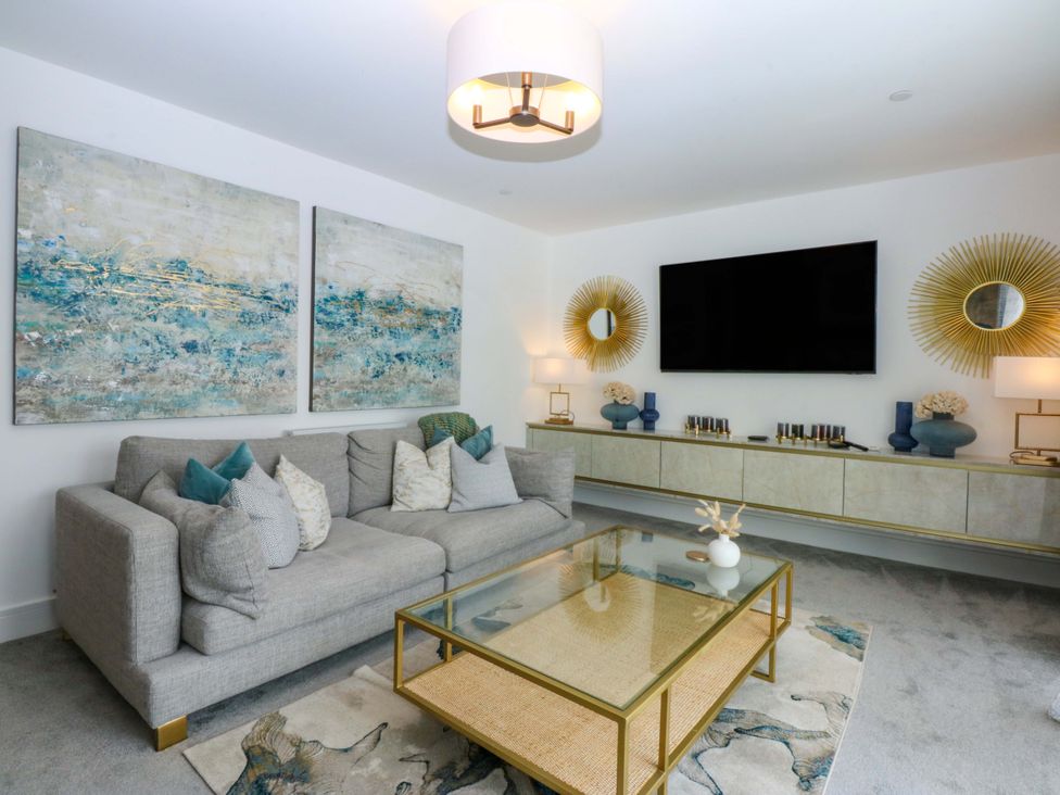 A living room with a sofa and coffee table at 2 Glan Yr Aber in Colwyn Bay