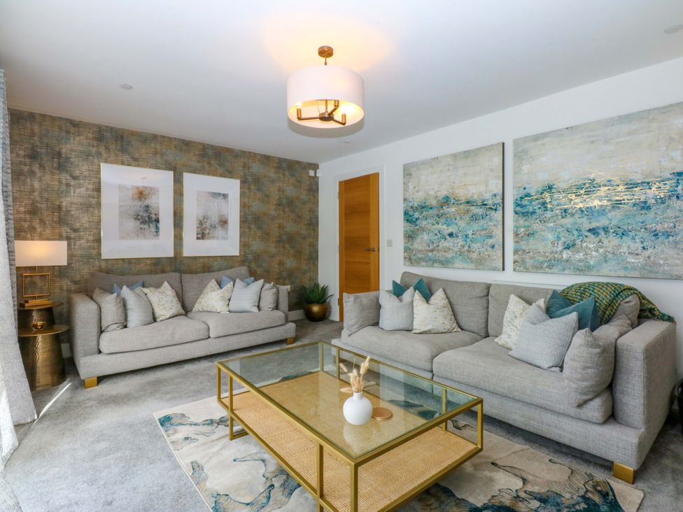 A living room with sofas and a coffee table at 2 Glan Yr Aber Colwyn Bay