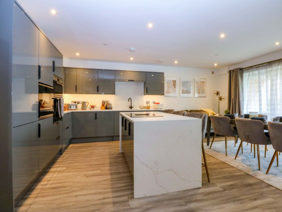 A kitchen with modern cabinets and an island at 2 Glan Yr Aber in Colwyn Bay