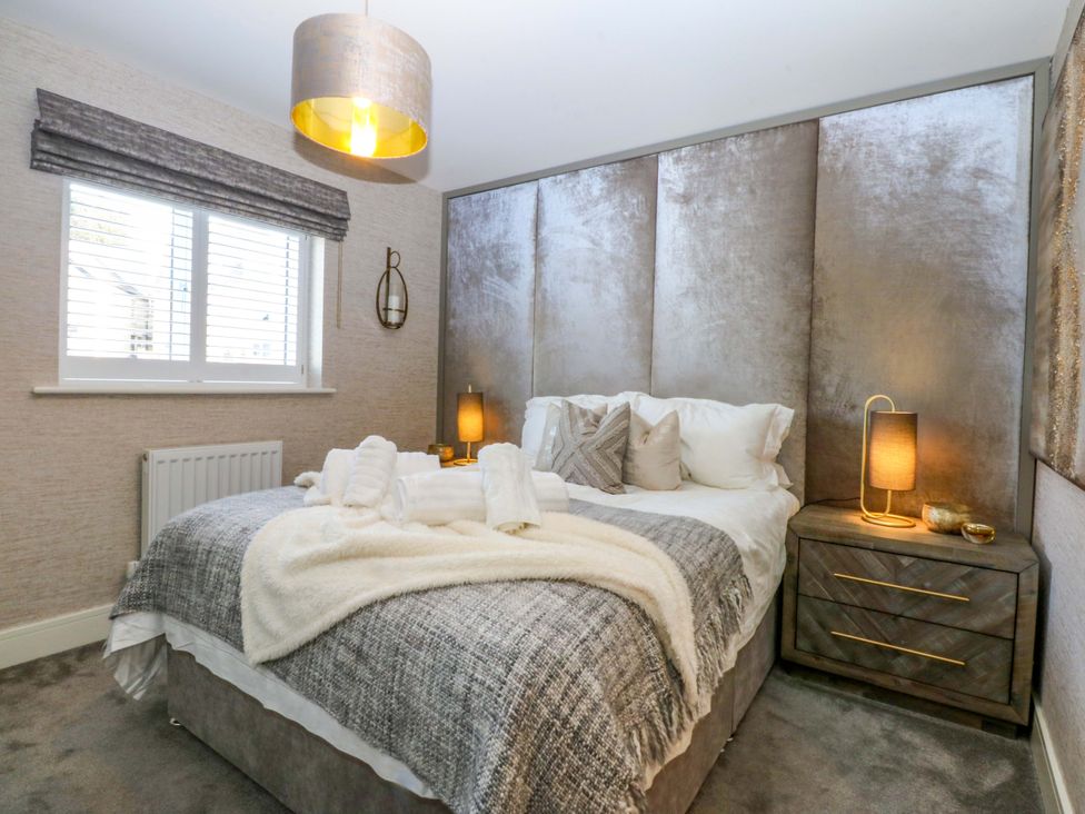A bedroom with a bed and bedside table at 2 Glan Yr Aber in Colwyn Bay