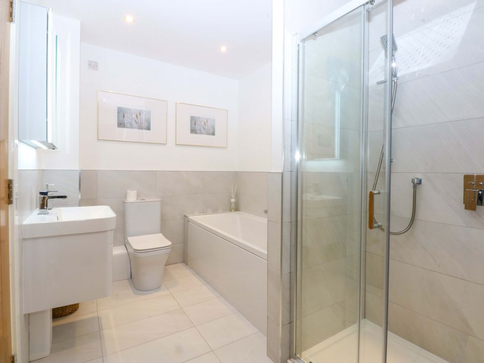 A bathroom featuring a bathtub, toilet, and shower at 2 Glan Yr Aber in Colwyn Bay