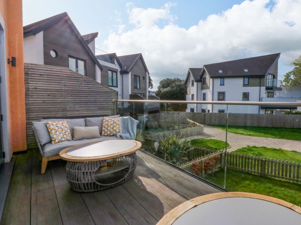 A balcony with a sofa and coffee table at 2 Glan Yr Aber in Colwyn Bay