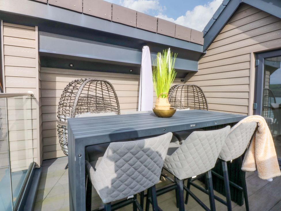 A balcony with a bar table and stools at 2 Glan Yr Aber Colwyn Bay