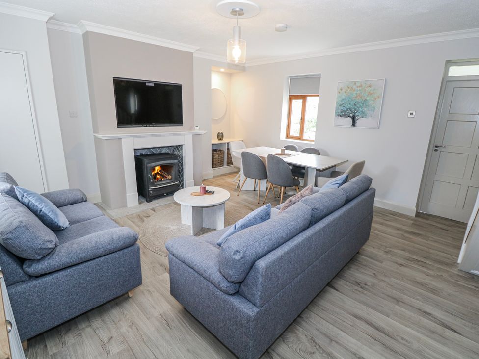 A living room with a television and fireplace at Ballina in Inverin
