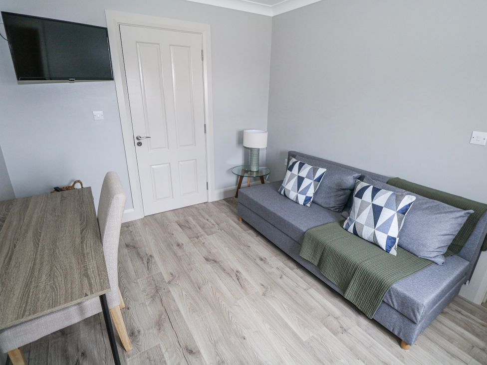 A living room with a sofa and a television at Ballina in Inverin