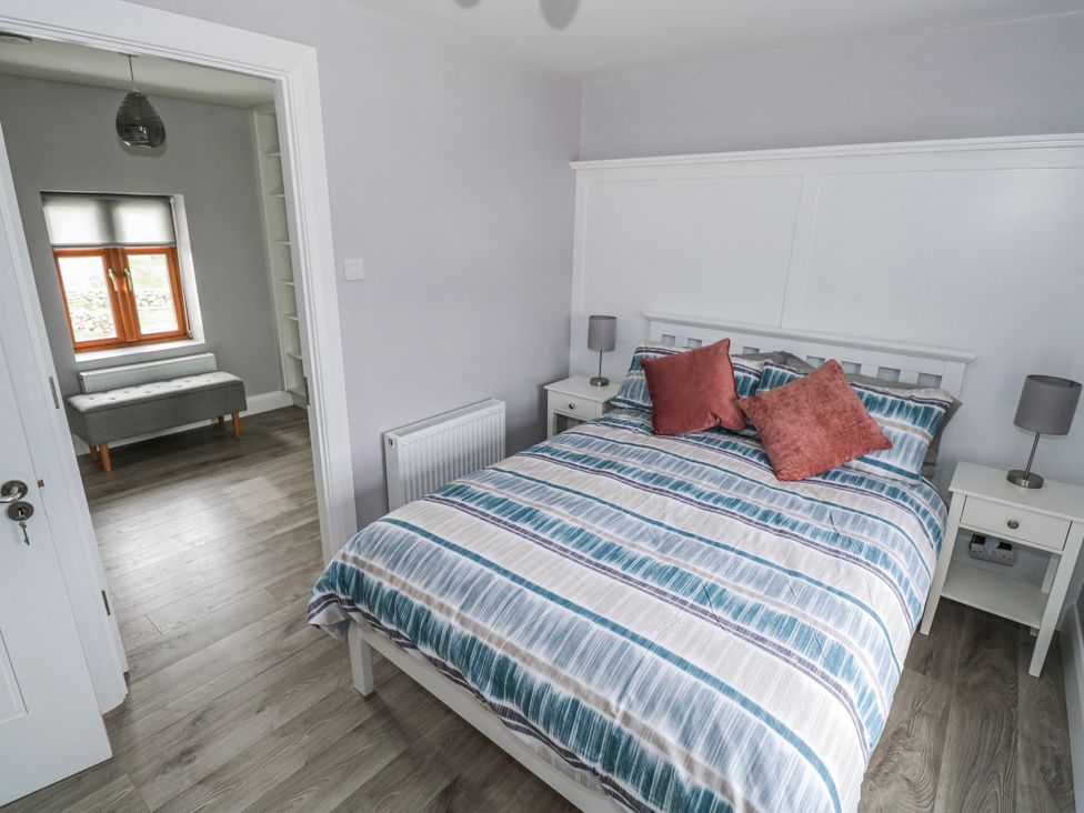 A bedroom with a bed and window at Ballina in Inverin