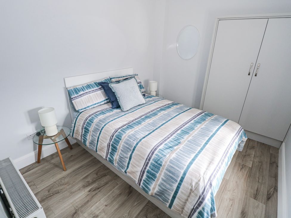 A bedroom with a bed and nightstand at Ballina in Inverin