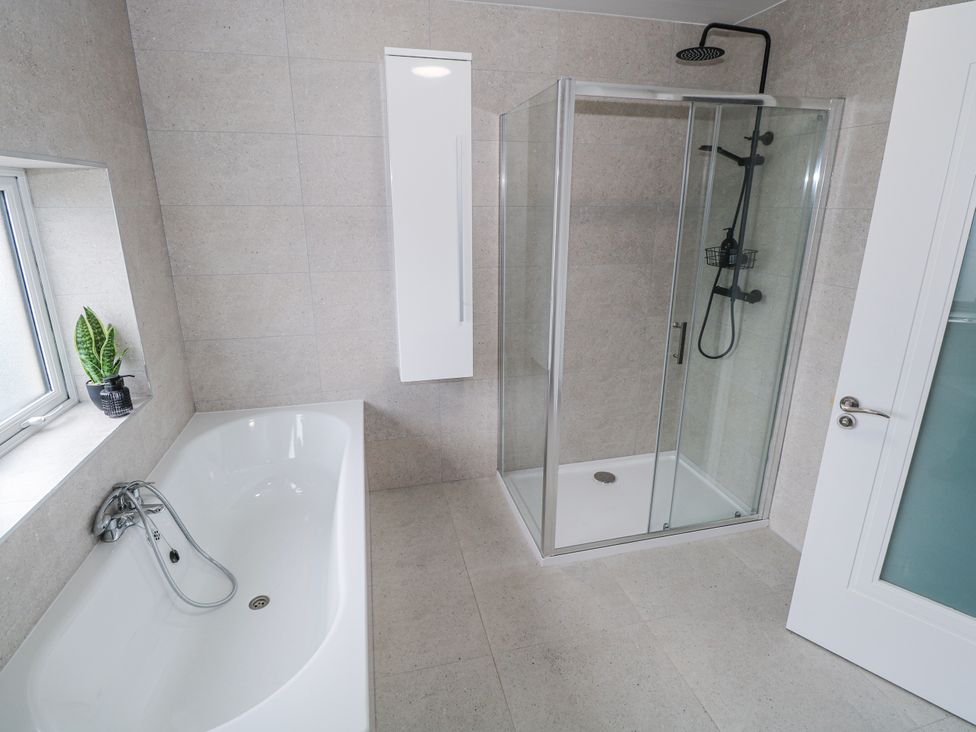 A bathroom with a shower and bathtub at Ballina in Inverin