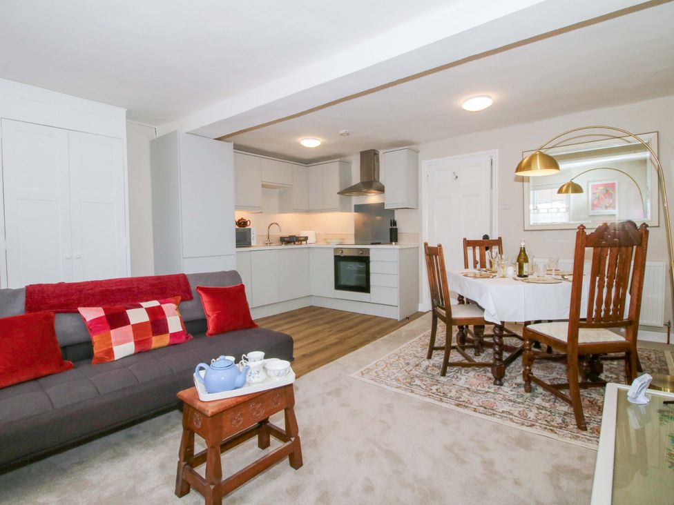 A living room with a dining area and kitchen at The Apartment at the Grey House in Albrighton