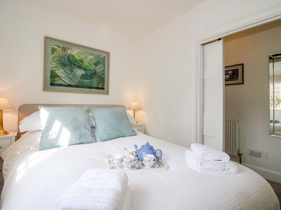 A bedroom with a bed and tea set at The Apartment at the Grey House in Albrighton