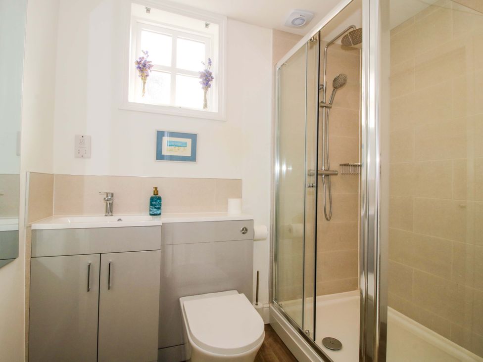 A bathroom with a shower and sink at The Apartment at the Grey House Albrighton