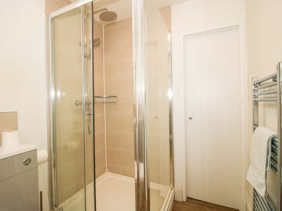 A bathroom with a shower and towel rail at The Apartment at the Grey House in Albrighton