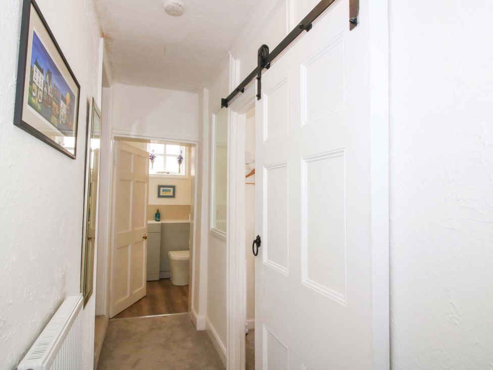 A hallway leading to a bathroom at The Apartment at the Grey House in Albrighton