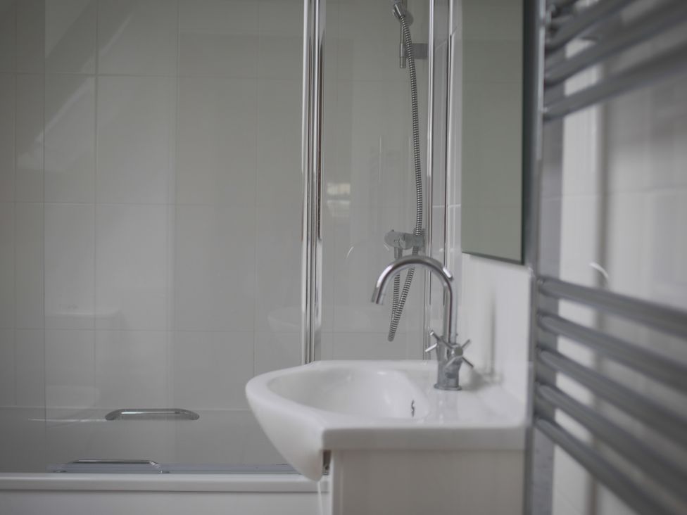 A bathroom with a shower and sink at Stanbridge Cottage in Malmesbury