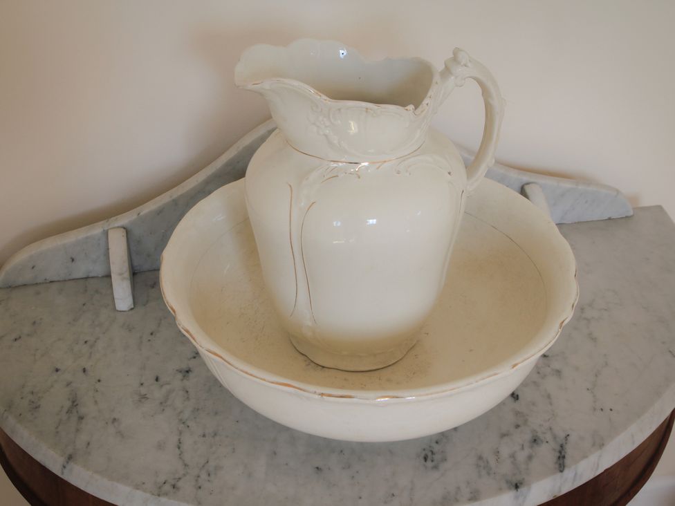 A pitcher and bowl on marble surface at Stanbridge Cottage in Malmesbury