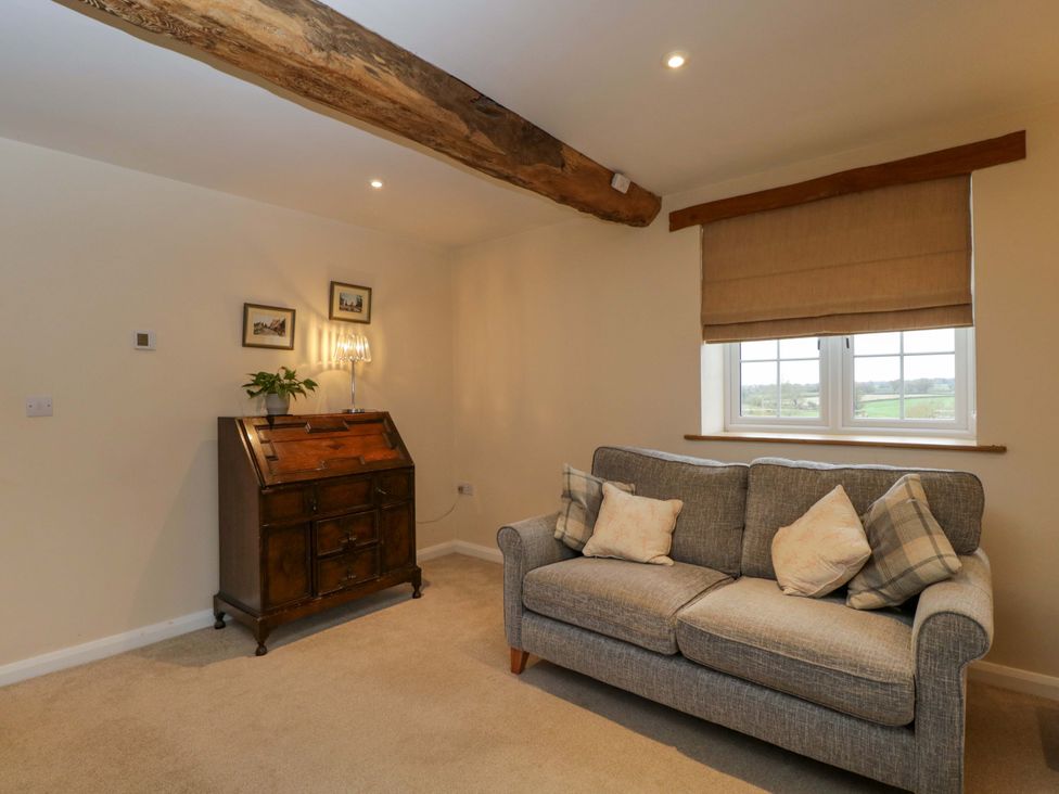 A living room with a sofa and a window at Stanbridge Cottage in Malmesbury
