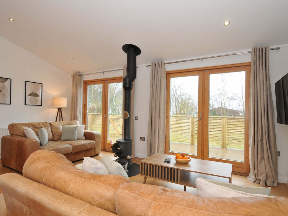 A living room with a fireplace and coffee table at 4 Southern Place in Dobwalls