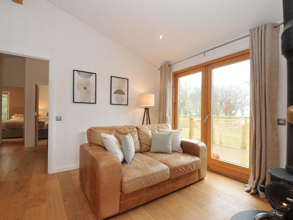 A living room with a sofa and lamp at 4 Southern Place in Dobwalls
