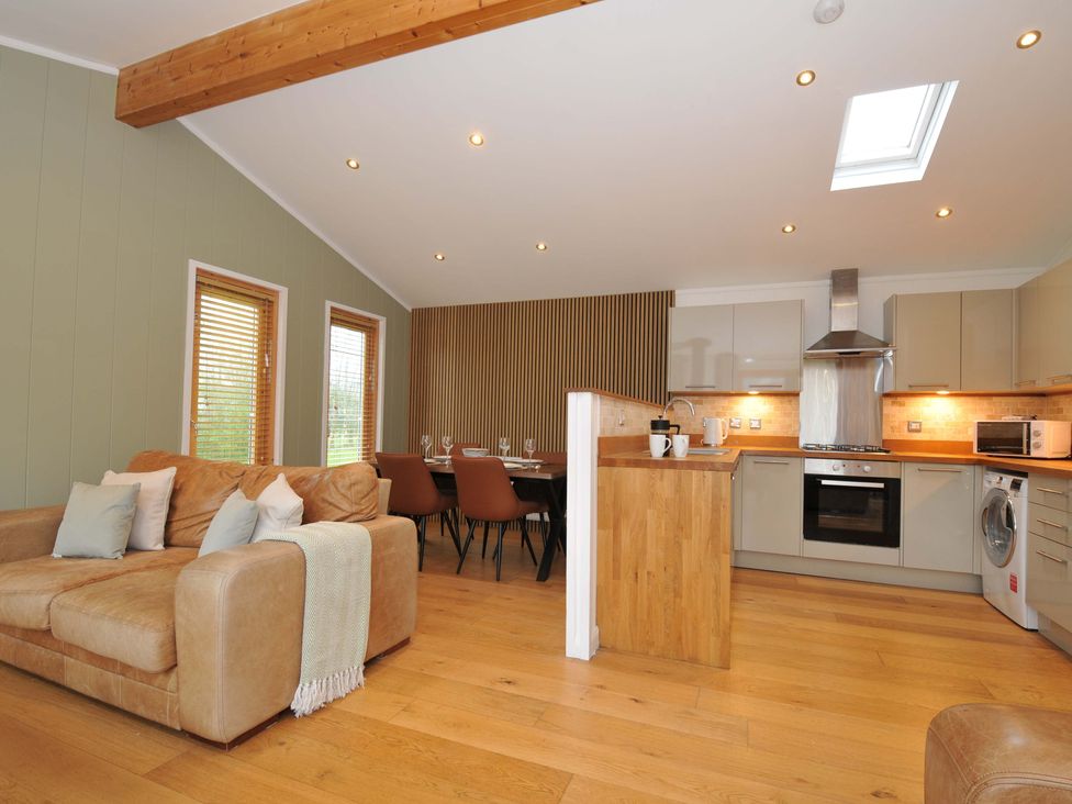 A living room with a sofa and dining area at 4 Southern Place in Dobwalls
