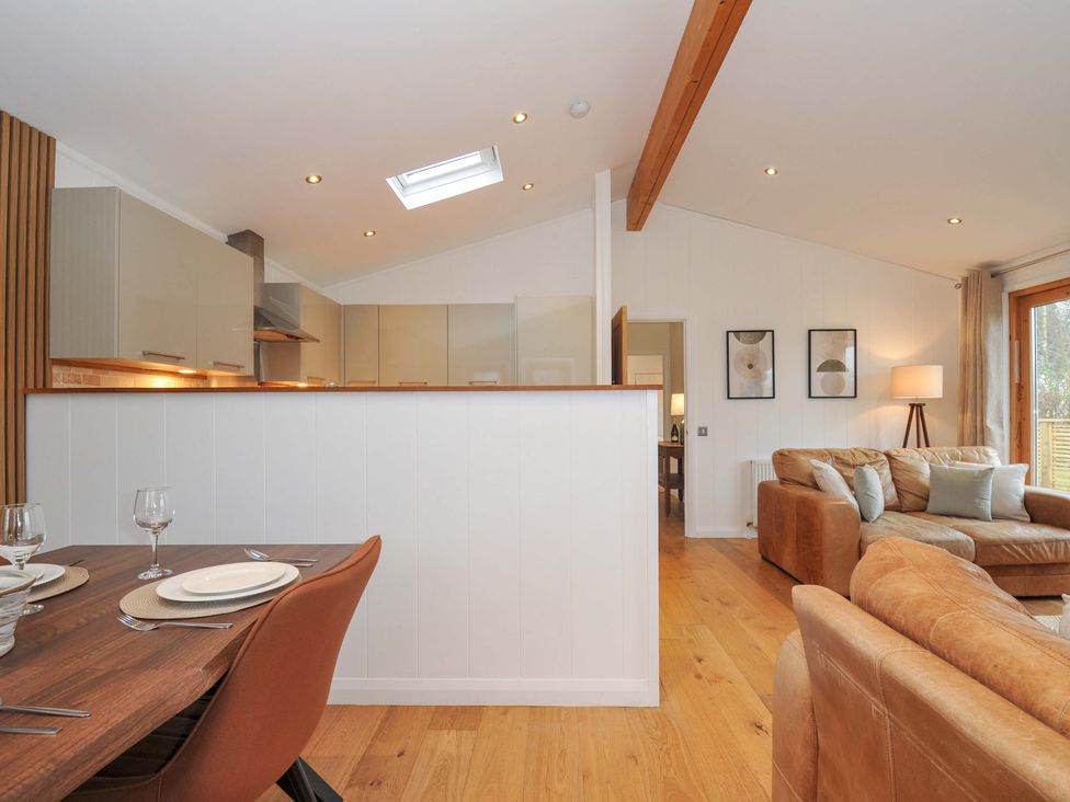A dining area with table and kitchen in view at 4 Southern Place in Dobwalls