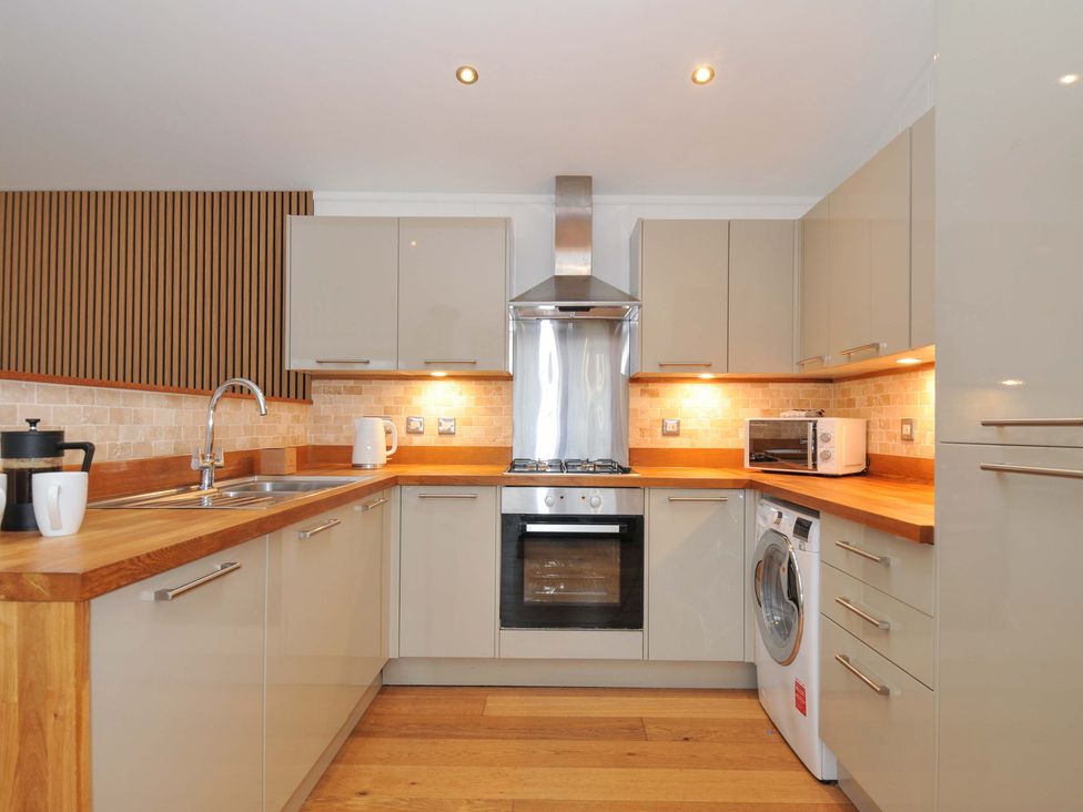 A kitchen with modern appliances and wooden countertop at 4 Southern Place in Dobwalls